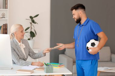 Teachers working in school office