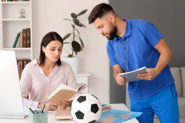 Teachers working in school office