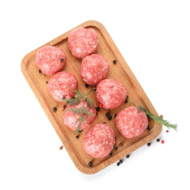 Board with raw meat balls, peppercorns and dill on white background