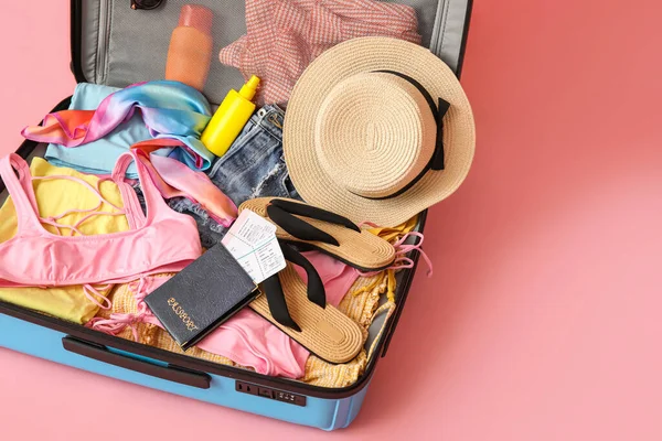 Open Suitcase Clothes Passport Tickets Beach Accessories Pink Background — Zdjęcie stockowe