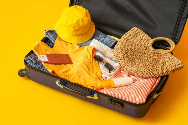 Suitcase Clothes Beach Accessories Ticket Passport Yellow Background — Zdjęcie stockowe