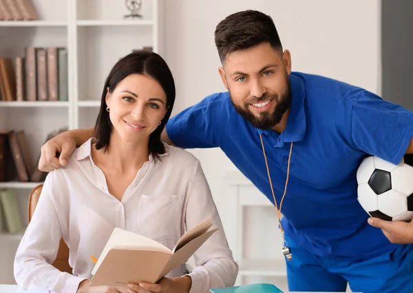 Teachers working in school office
