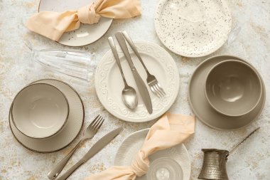 Set of stylish tableware on grunge background, top view