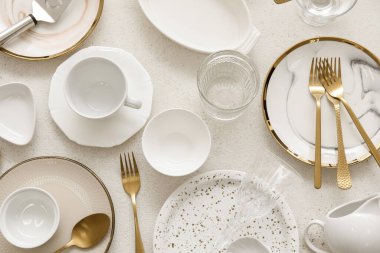 Set of stylish tableware on light background, top view