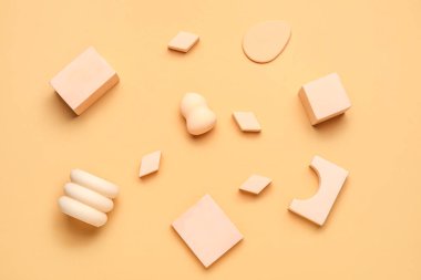 Makeup sponges with decor on beige background