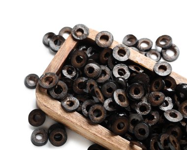 Wooden board of cut black olives on white background, closeup
