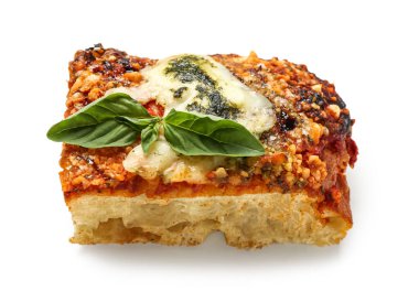 Piece of tasty Italian pie with mozzarella and pesto sauce on white background