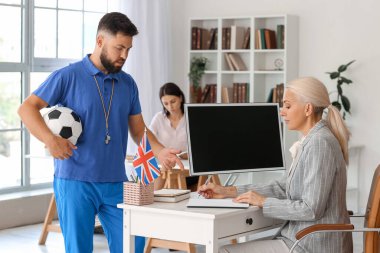 Teachers working in school office