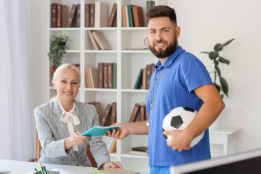 Teachers working in school office