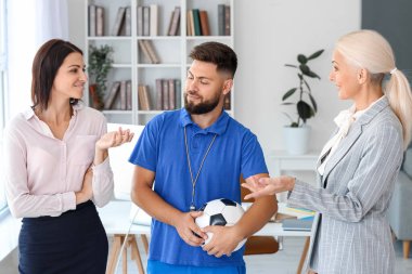 Different teachers working in school office