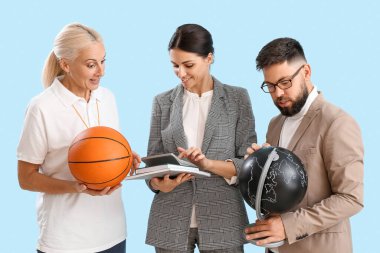 Teachers with ball, globe and books on blue background