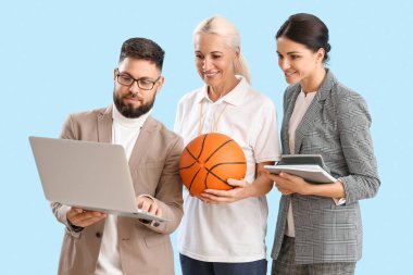 Teachers with laptop, ball and books on blue background