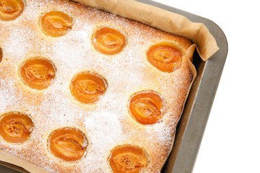 Baking tray with tasty apricot pie on white background, closeup