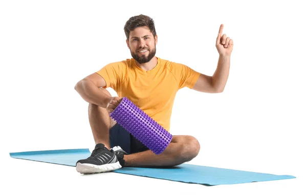 Young Man Foam Roller Pointing Something White Background — Stock Photo, Image