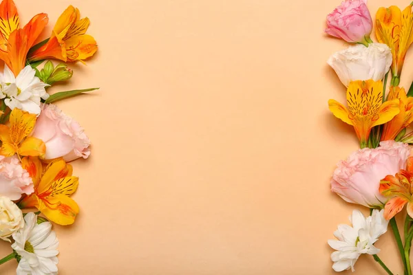 Frame made of beautiful flowers on beige background