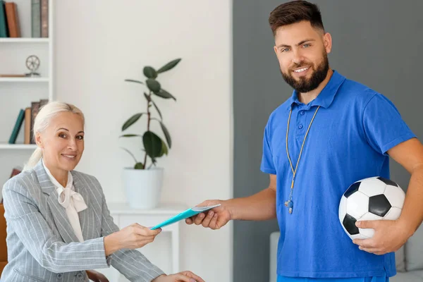 Teachers working in school office