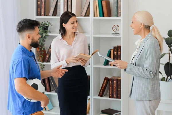 Teachers working in school office