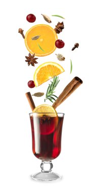 Glass of tasty mulled wine and ingredients on white background