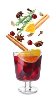 Glass of tasty mulled wine and ingredients on white background
