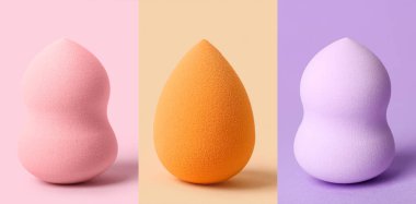 Set of makeup sponges on colorful background