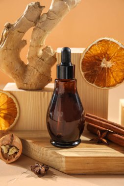 Composition with bottle of essential oil and wooden decor on table, closeup