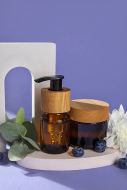 Composition with natural cosmetics and plaster decor on lilac background, closeup