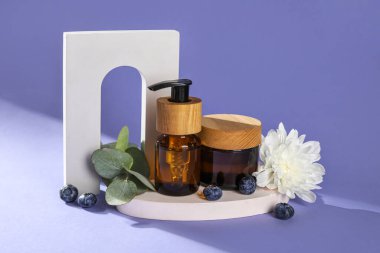 Composition with natural cosmetics and plaster decor on lilac background