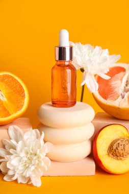 Composition with bottle of essential oil, fruits, flowers and plaster stands on color background, closeup