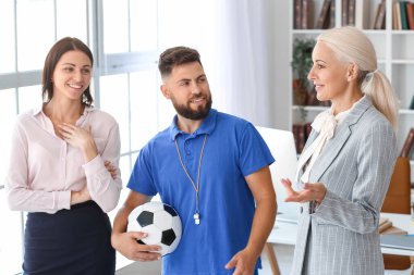 Different teachers working in school office