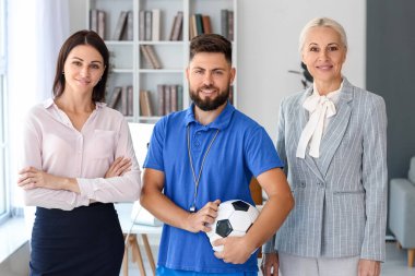Different teachers working in school office