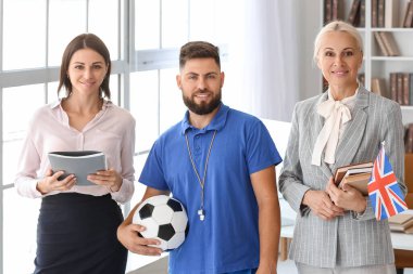 Different teachers working in school office