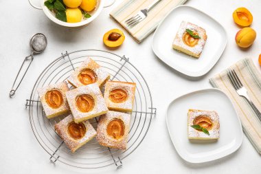 Composition with tasty apricot pie on light background