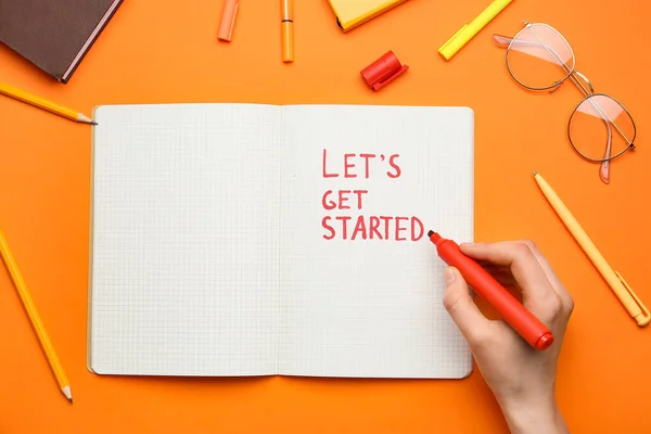 Female Hand Writing Text Let Get Started Notebook Orange Background — 图库照片