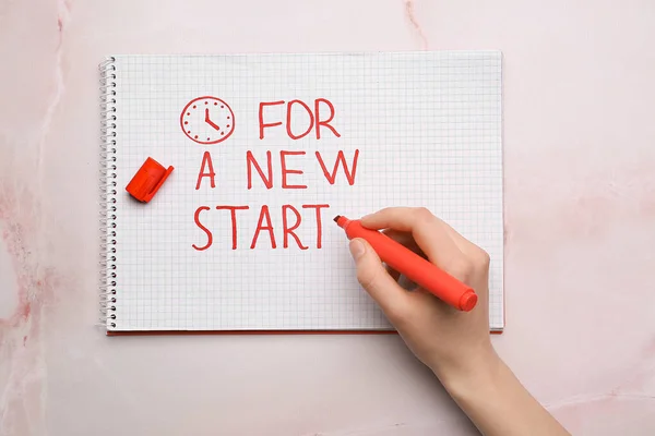 Female Hand Writing Text New Start Notebook Light Background — Fotografia de Stock