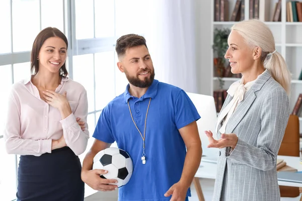 Different teachers working in school office