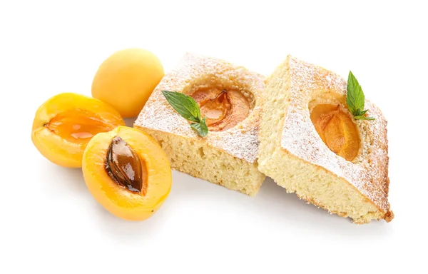 Pieces of tasty apricot pie and fresh fruits on white background