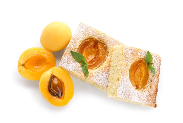 Pieces of tasty apricot pie and fresh fruits on white background