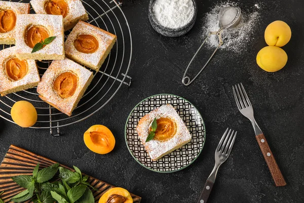 Composition with tasty apricot pie on dark background
