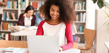 African-American female student preparing for exam in library