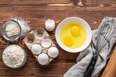 Composition with different ingredients for baking on wooden background