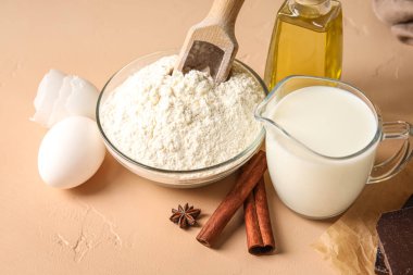 Ingredients for baking on beige table, closeup