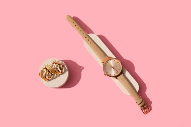 Showcase pedestals with stylish accessories on pink background