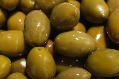 Many green olives as background, closeup