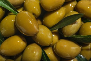 Heap of green olives as background, closeup