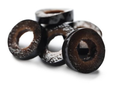 Heap of cut black olives on white background