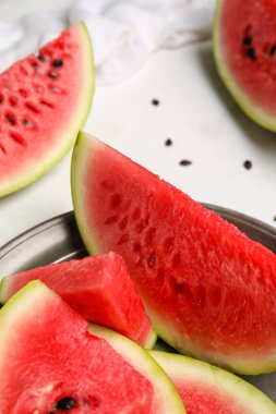 Plate with slices of watermelon on white background, closeup