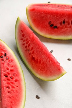 Slices of watermelon with seeds on white background