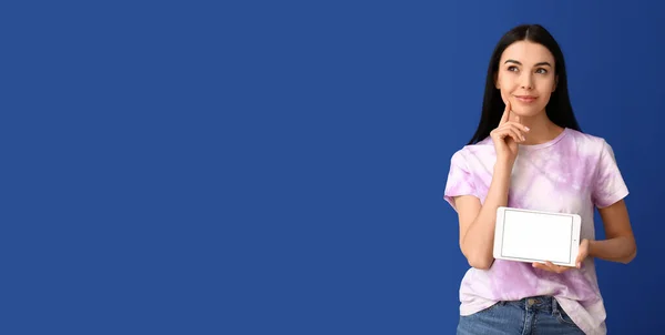 Thoughtful Young Woman Holding Tablet Computer Blue Background Space Text — Stock Fotó