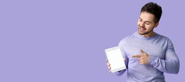 Young Man Holding Tablet Computer Lilac Background Space Text — Stock Fotó