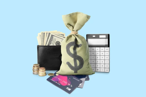 Money bag with wallet, cash, credit cards and calculator on blue background